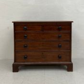 A Georgian mahogany bachelor's chest having a rectangular top with brushing slide over an