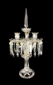 A three light crystal epergne or centrepiece candelabrum having a faceted spire finial over a