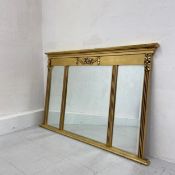 A vintage 19th century style gilt triptych mirror having a moulded cornice with a carved floral swag