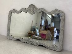 A large painted wall or overmantle mirror in the French 19th century style having a shaped plate