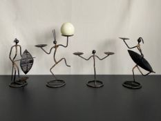Four Danish mid-century figural wrought metal and rattan candlesticks by Laurids Lonborg. H.30cm