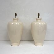 A pair of large vintage cream crackle glazed ceramic urn or baluster form table lamps. (One with a