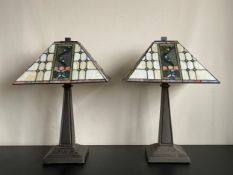 A pair of vintage Tiffany style table or bedside mission lamps each having a cube finial over a