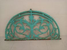 A C.1900 cast and painted iron window transom having an arched top with all-over scrolling