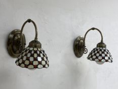 A pair of contemporary Tiffany style wall lights each having a moulded brass plate with a curved
