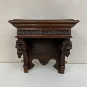 A 19th century Gothic Revival oak wall bracket having a moulded cornice with carved flowerhead and