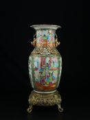 A possibly 19th century Cantonese famille rose baluster form vase having an everted scalloped rim