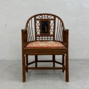 A vintage Oriental bamboo armchair having a shaped wishbone back and arms with a spindled and