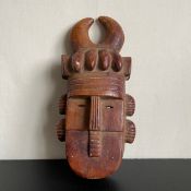 A 20th century West African carved tribal Toma mask with pigment from Liberia. L.40cm