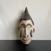 A West African carved tribal mask from the Igbo people depicting a Agbogho Mmuo or maiden spirit
