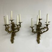 A pair of French Rococo style brass wall sconces each having four scrolling foliate branches