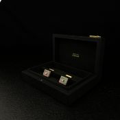 A stylish pair of gentlemen's Zilli cufflinks each having a central emerald-cut diamond (approx. 0.