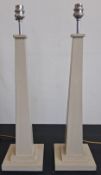 A pair of contemporary painted table lamps of simple square column form with tapering stems raised