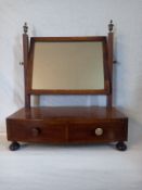 A 19th century mahogany toilet mirror having a rectangular plate in a crossbanded frame with a swing