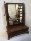 A Georgian mahogany toilet mirror having a rectangular plate in a simple frame with shaped corners