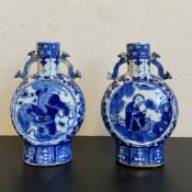 A near pair of possibly 19th century blue and white Chinese moon flasks each having a cylindrical