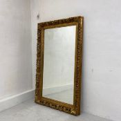 A large wall or dressing mirror in the French 19th century style having a rectangular bevelled plate