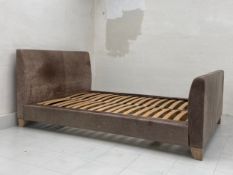 A contemporary bed frame having a simple distressed leather head and footboard - fits double 135 x