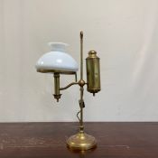 A C.1900 electrified brass student table lamp having a narrow stem with hoop finial over a height
