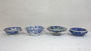 A collection of four 19th century and later blue and white and polychrome porcelain sponge dishes in