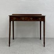 A Georgian mahogany side table having a rectangular top with a short gallery back over a pair of