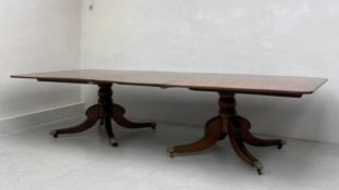A large and impressive Regency mahogany extending twin pedestal dining table with one additional