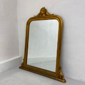 A gilt overmantel mirror in the French 19th century style having a rectangular plate with curved
