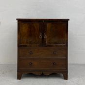 A small Georgian mahogany commode having a square top over an arrangement of two panelled cabinet