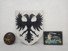 A vintage painted wooden shield bearing a double-headed dragon symbol, possibly the French coat-of-