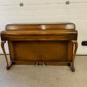A mid century walnut cased Kemble Minx mini piano with iron frame. H.88 W.131cm
