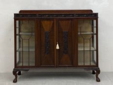 An Edwardian mahogany display cabinet having a rectangular top with gallery back and an