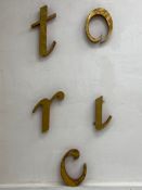 A collection of five painted metal fairground letters. L.44cm (the letter t)