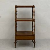 A 19th century rosewood three tier whatnot having a square top with pierced brass gallery surround