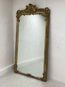 A large and impressive 19th century carved giltwood overmantel mirror with scrolling Rococo cresting
