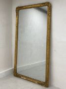 A large and impressive 19th century giltwood and gesso overmantel mirror with flowerhead