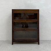An early 20th century Angus Gunn three sectional Globe Wernicke style oak bookcase having three