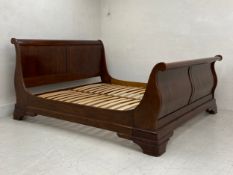A contemporary mahogany sleigh bed in the 19th century Continental style. Fits mattress up to 6ft
