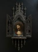 A late 19th century oil on ceramic panel, Jesus wearing the crown of thorns, in a gothic carved
