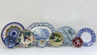 A mixed collection of studio pottery and other ceramic plates to include a large 19th century blue