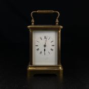 A 19th century brass carriage clock with painted dial signed Lange, with key. H.18cm