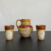 A pair of Doulton stoneware beakers and the matching jug, National Rifle Association 1860-89 in