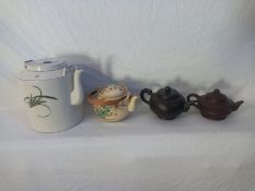 A collection of four Oriental teapots. H.19cm Largest