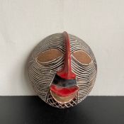 A late 20th century Central African carved Bamileke style mask with pigment from Cameroon. L.26.5cm