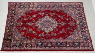 A large Persian style Sarouk carpet having a having a central diamond lozenge medallion surrounded