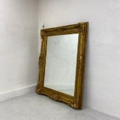 A large wall mirror in the French 19th century style having rectangular bevelled plate in a