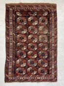 A possibly 19th century Turkoman Saryk carpet having three rows of eight guls in blues, reds and