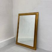 A large contemporary wall mirror having a rectangular plate in a simple gilt and moulded frame. H.