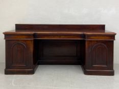 A mid 19th century mahogany sideboard having a breakfront top with a gallery over three secret