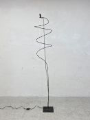 A contemporary floor standing lamp signed to base. H.183cm