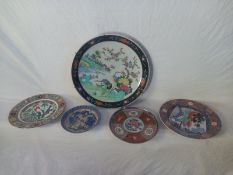 A large 19th century Japanese plate decorated with birds and blossom along with a collection of four